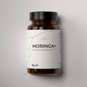 Brown supplement bottle labeled 'Moringa+' with a white label on a gray background
